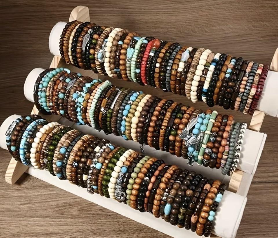 Display stand filled with men's wood-bead bracelets in natural wood tones, colors, and metal accents